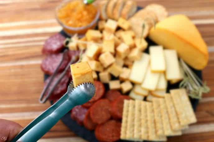 Smoked Cheese On A Grill - An Easy How To Tutorial!, Smoked cheese on the barbecue grill served on a platter with smoked meat, crackers and jam.