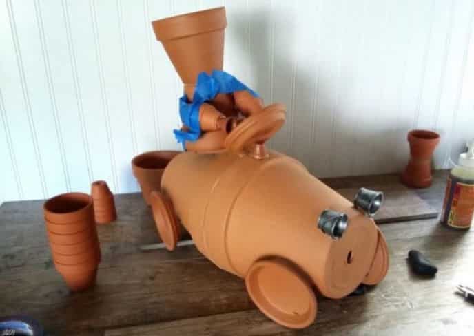 Clay Pot Garden Sculpture Race Car Craft, Gluing clay pot race car and driver together.