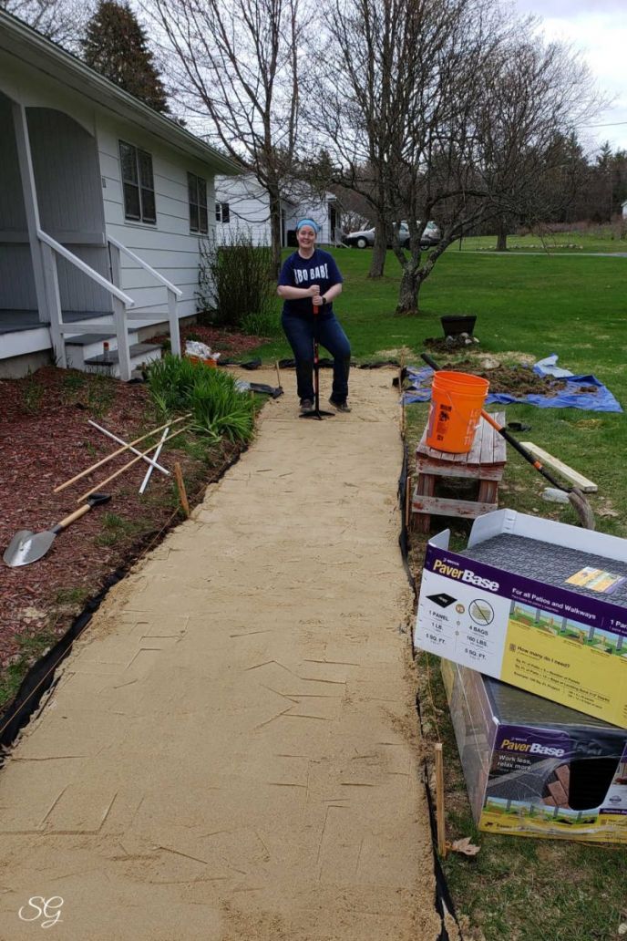 How To Install A DIY Paver Walkway, Installing the paver base sand for a DIY paver walkway installation.