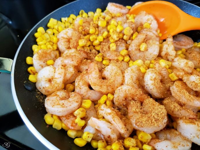 Layered Crunchy Shrimp Tostadas Recipe, Shrimp and corn tostadas, cooking shrimp and corn in a skillet