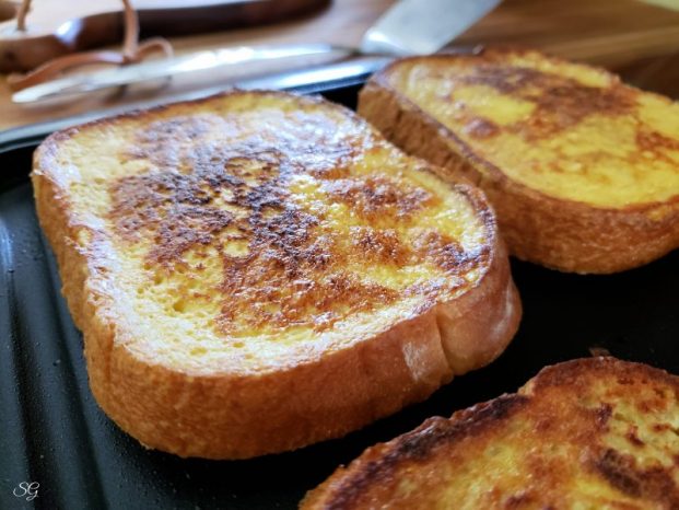 French Toast Roll Ups, French toast browning on a skillet, cooking to make French toast dessert roll ups. #minustheshell