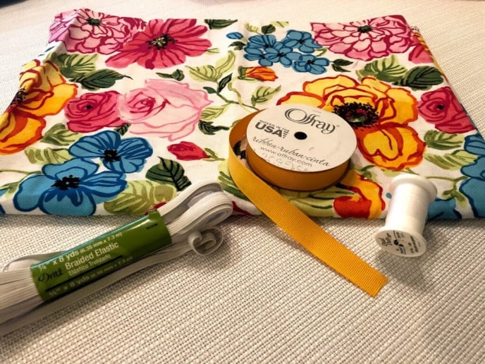 DIY Plastic Bag Holder, Fabric, ribbon, elastic, and thread, materials for the bag holder.