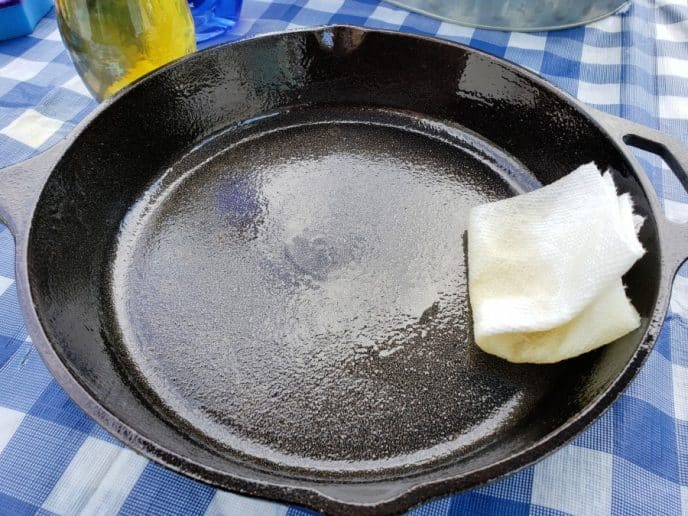 How To Clean A Rusty Cast Iron Skillet Seasoning a cast iron skillet with oil and paper towel