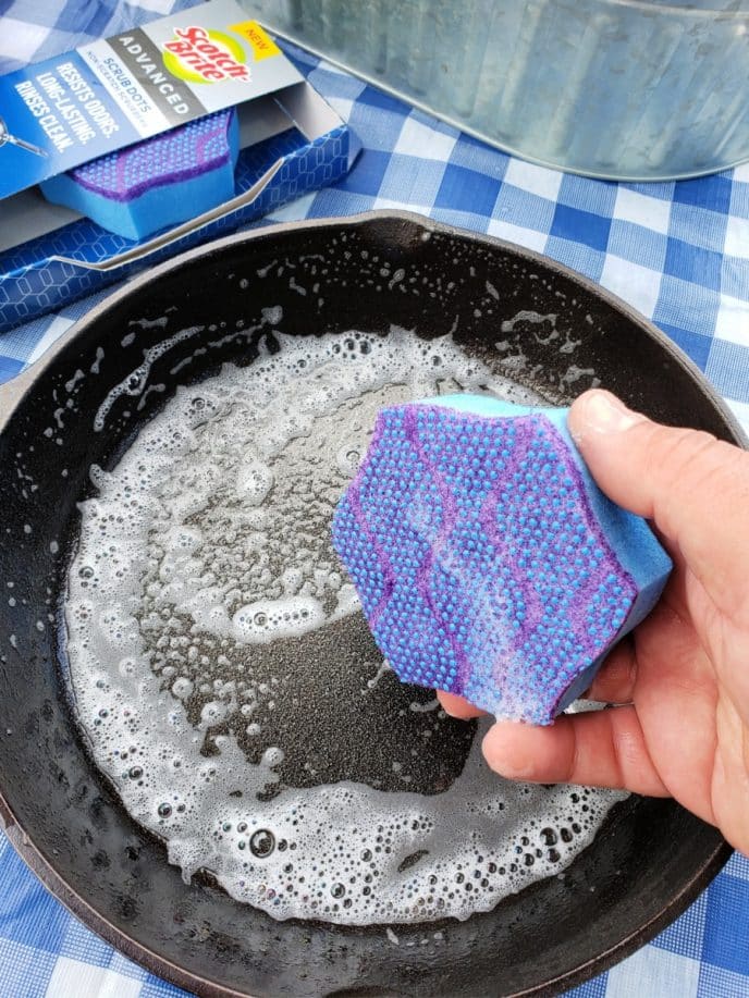 How To Clean A Rusty Cast Iron Skillet Cleaning a cast iron skillet with scrubbing dots sponge from Scotch-Brite