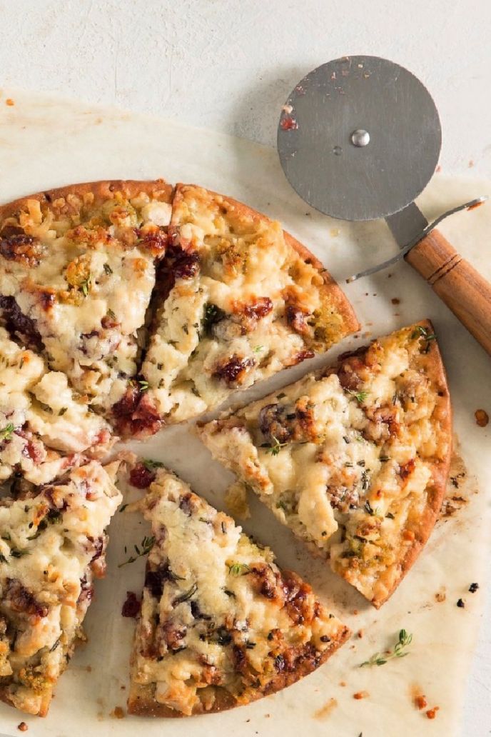 Thanksgiving Leftover Pizza, Turkey Pizza Thanksgiving leftovers recipe sliced with a pizza cutter lying next to the pizza