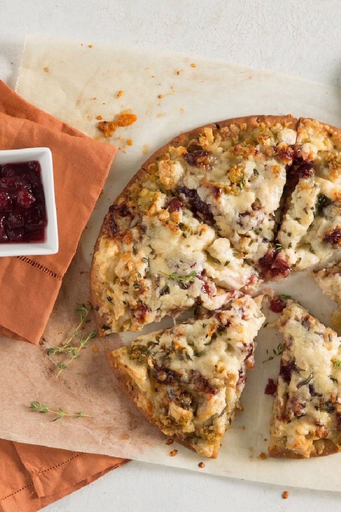 Thanksgiving leftover pizza recipe made with turkey, stuffing, cranberry sauce, cheese, crust, and herbs