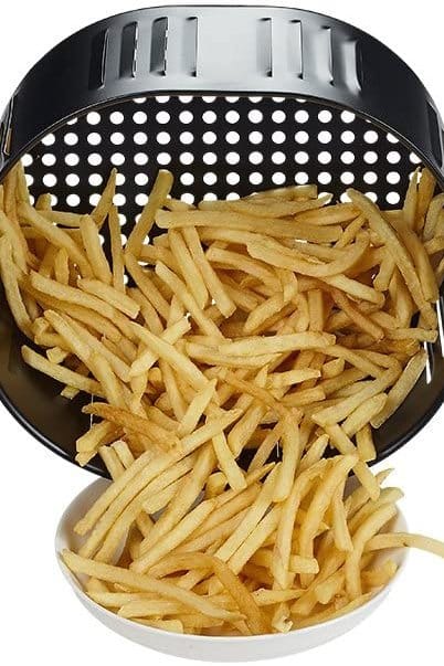 How To Use An Air Fryer French fries in air fryer basket being poured into a serving bowl.