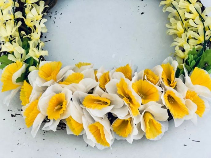 How to Make A Flower Wreath with Daffodils Attaching daffodils to the grapevine wreath.