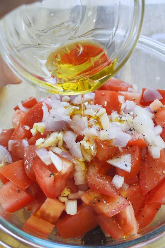 Tomato Salad Mixing ingredients to make tomato salad.