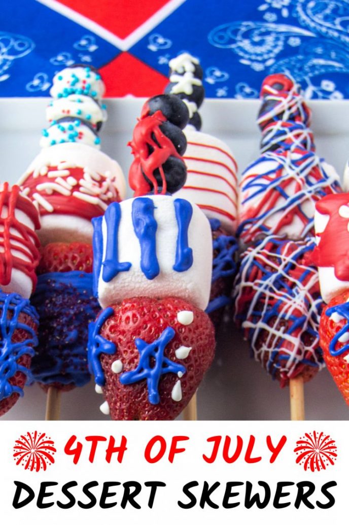 4th of July dessert fruit skewers drizzled with red, white, and blue chocolate melted candy.
