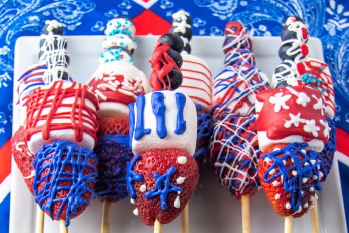 Easy 4th of July Dessert Fruit skewers with patriotic colorful chocolate decorations.