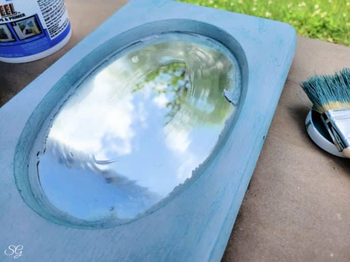 Painting A Mirror Frame Dry brush painting turquoise over gray on the mirror frame around the oval mirror