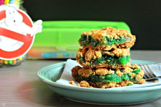 Cookie crumb bars with green jam between cereal cookie layers