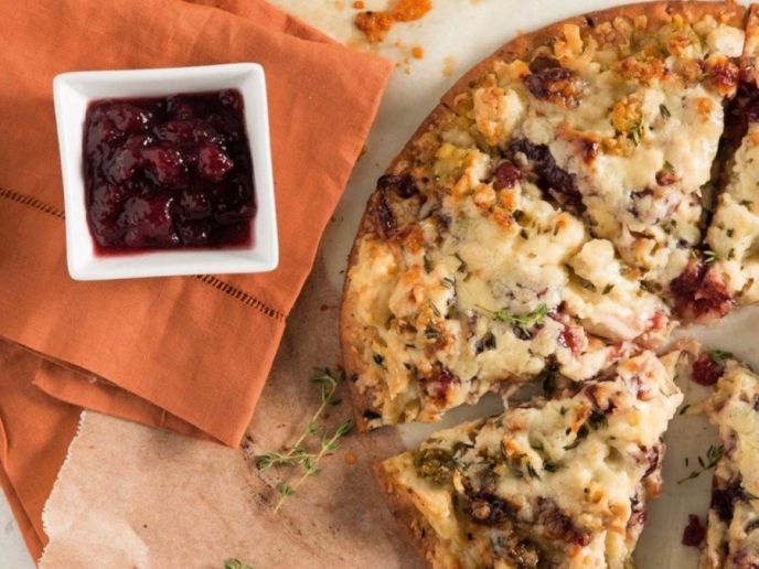 Turkey pizza made with leftover Thanksgiving food like turkey, cranberry sauce, and more.